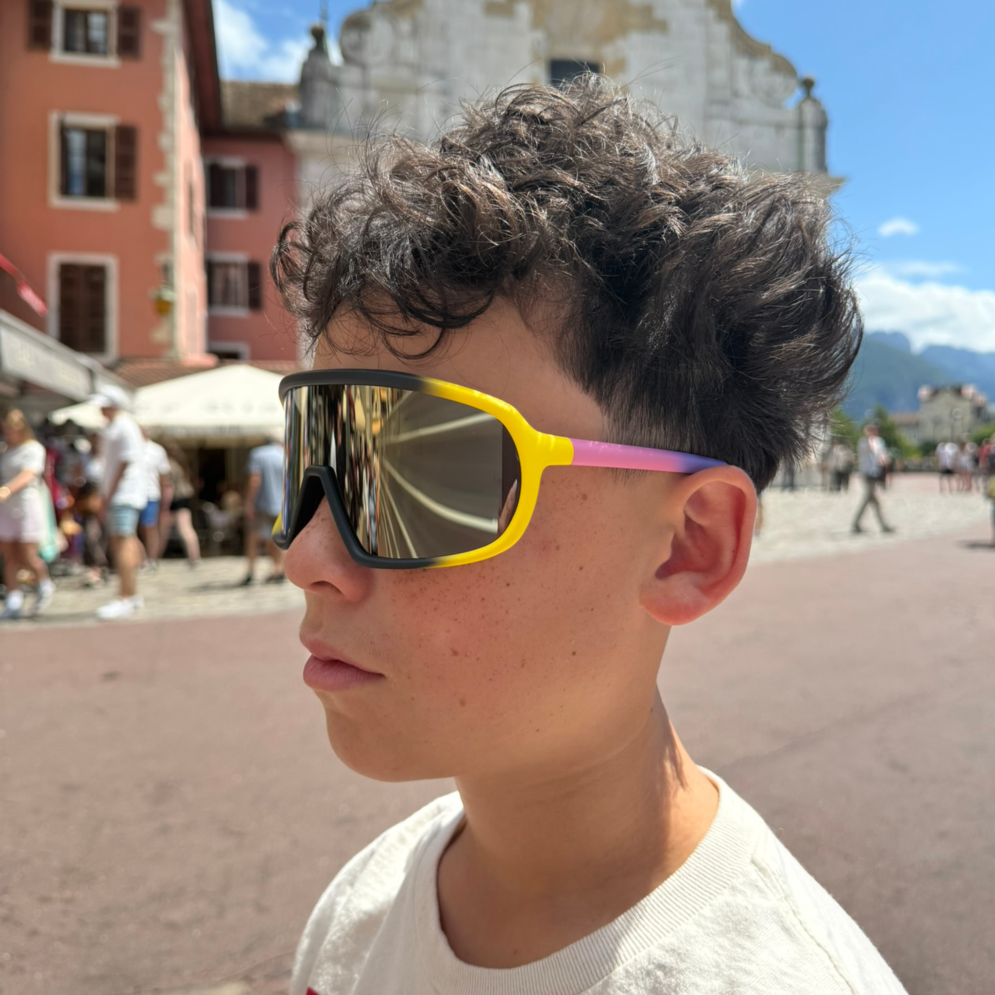 E12 precise impact-resistant sunglasses worn in an urban street setting, blending performance and lifestyle style.