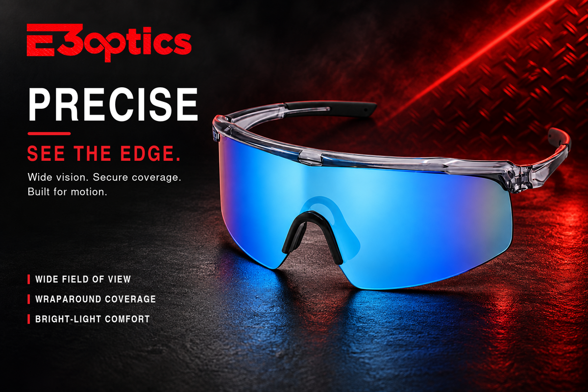 E3optics Precise sports sunglasses with a blue mirrored shield lens and clear frame, set against a dark textured background with red lighting and promotional text.
