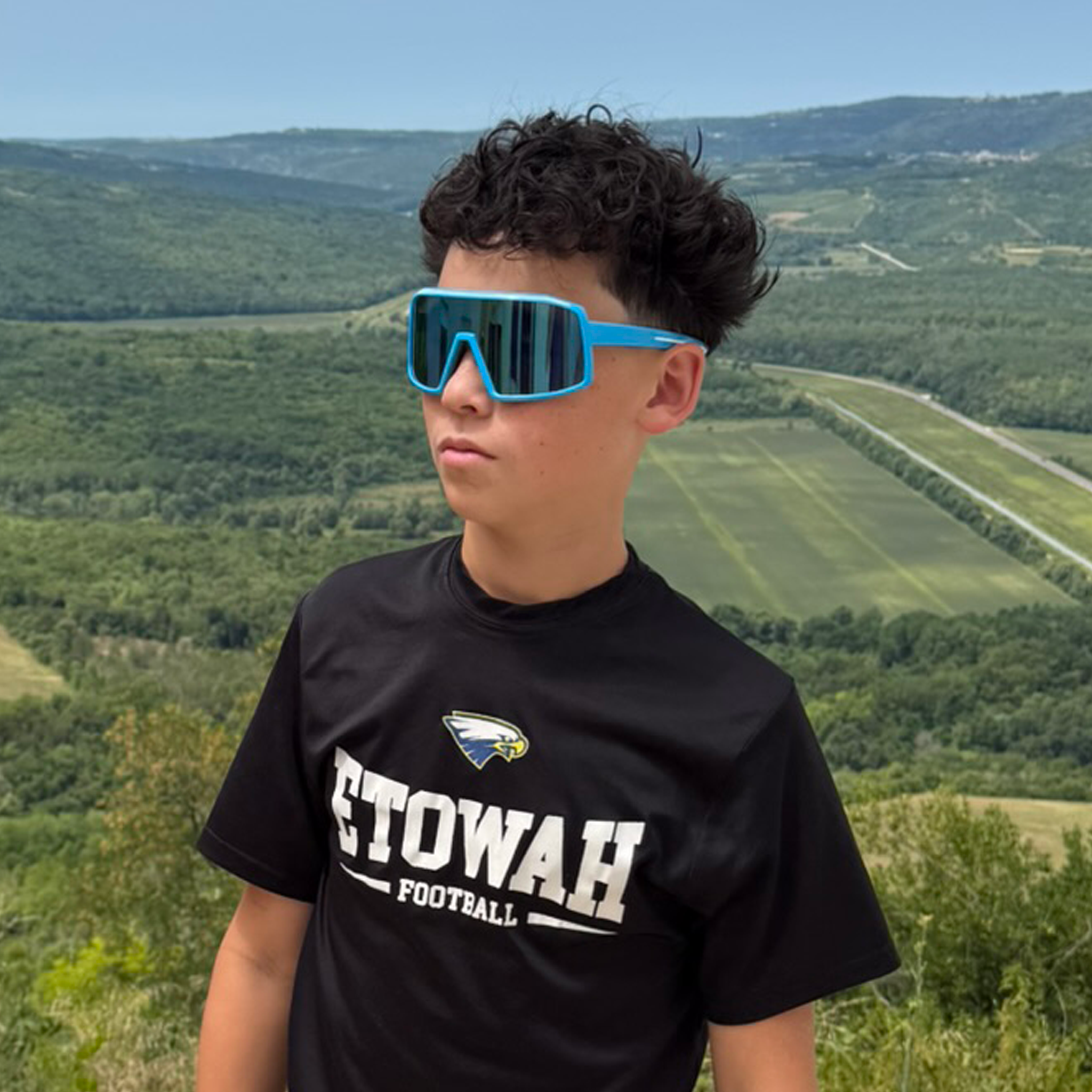 Man hiking with E3 Optics E11 precise lens sunglasses – impact resistant trail and outdoor eyewear.