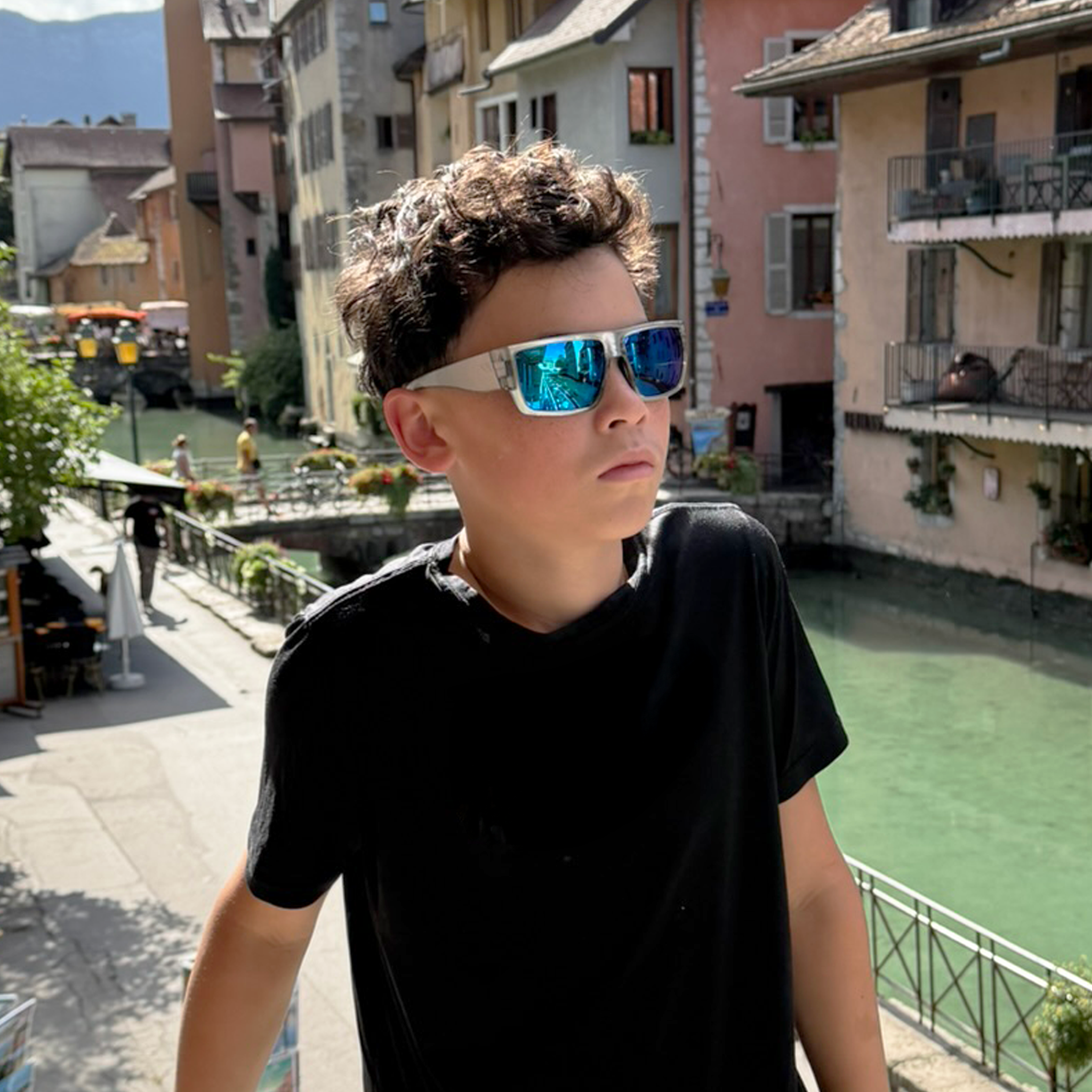 Teen wearing E3 Optics E18 floating polarized sunglasses for fishing, kayaking, and watersports