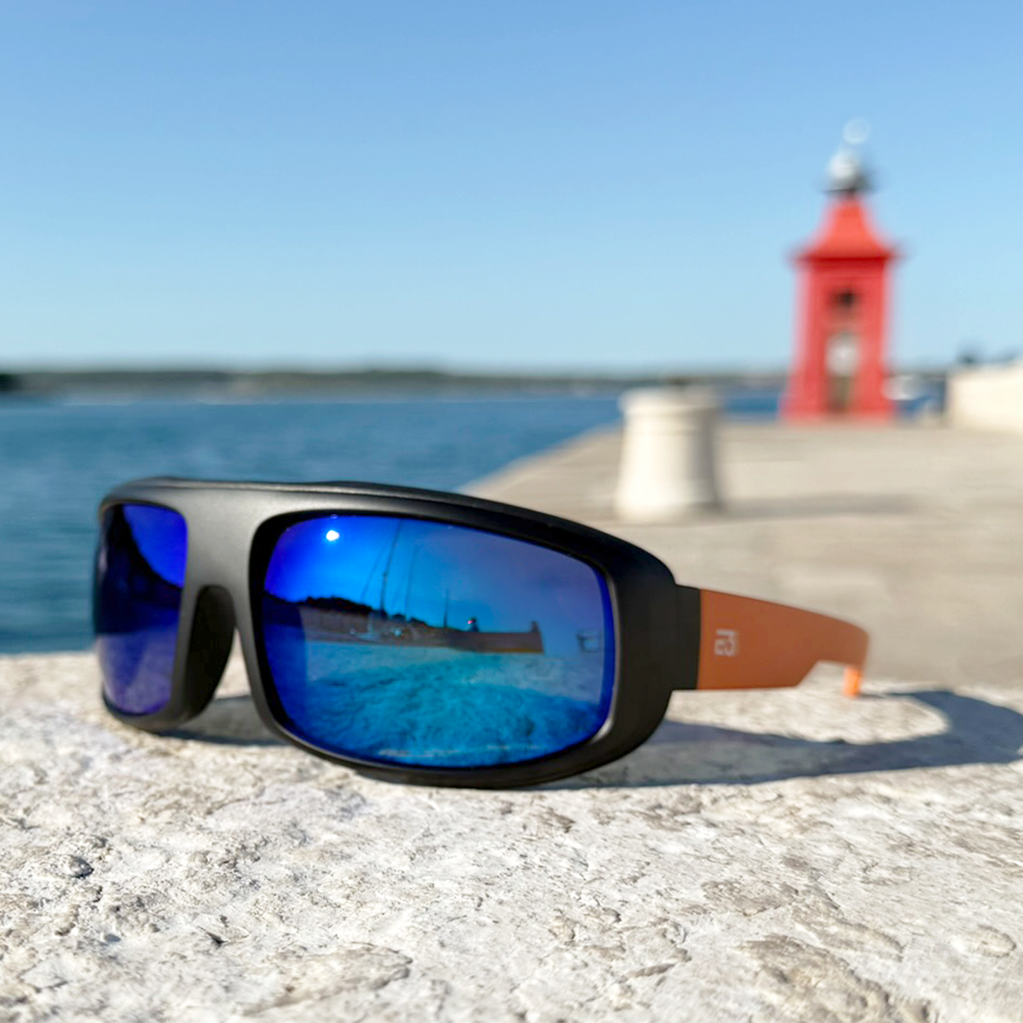E3 Optics E15 polarized sunglasses at lighthouse – glare reducing eyewear for boating and water sports.