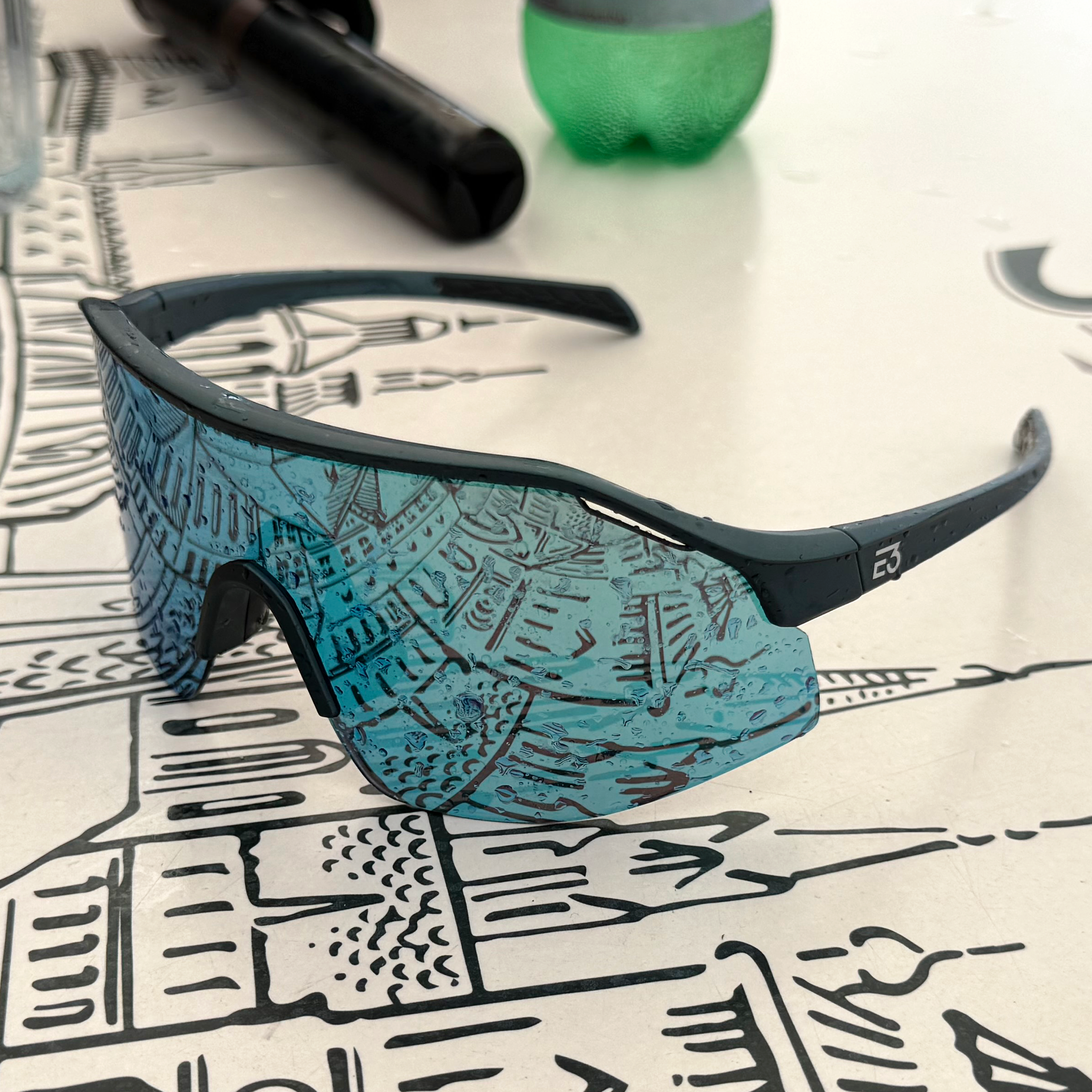 E3 Optics E7 Sunglasses – Matte Blue Frame Worn at Outdoor Café