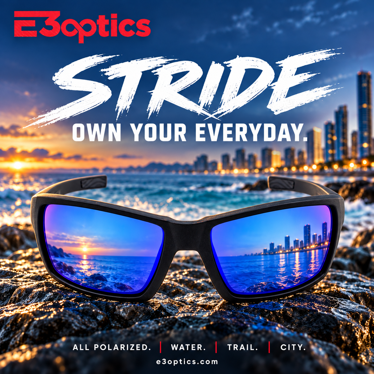 E3optics Stride sunglasses with a black frame and blue mirrored lenses, shown in the foreground with a coastal city and ocean sunset in the background. Large text reads 'E3optics STRIDE OWN YOUR EVERYDAY.